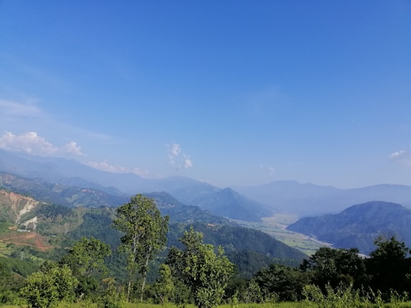 A scenic view of green hills under a clear blue sky.