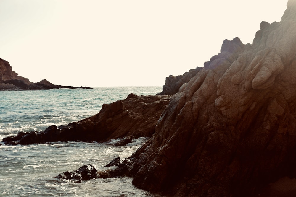 a rocky shore line with a body of water
