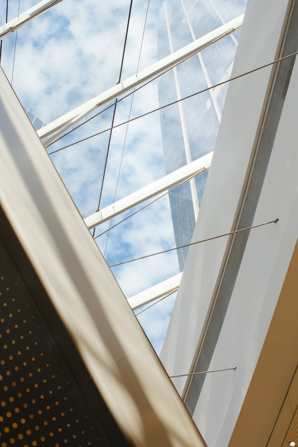 looking up at the glass roof of a building