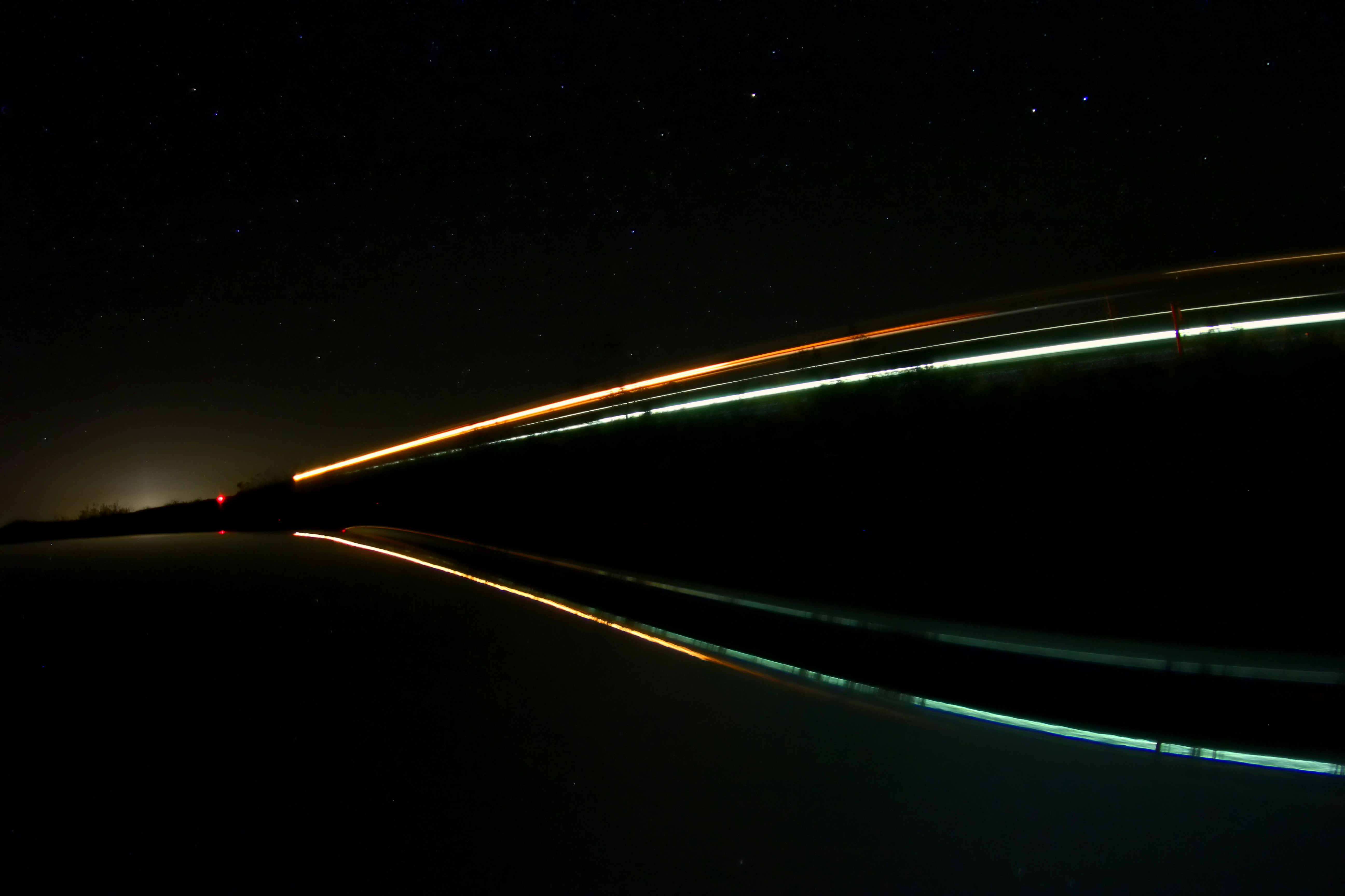 a long exposure photo of a bridge at night
