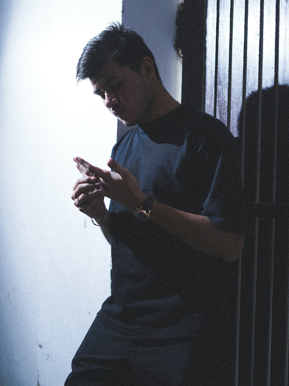 a man standing in front of a jail cell phone