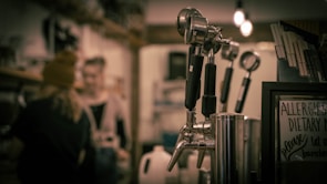 Close-up of freshly brewed coffee and tea drinks with sugar control machines in the background.