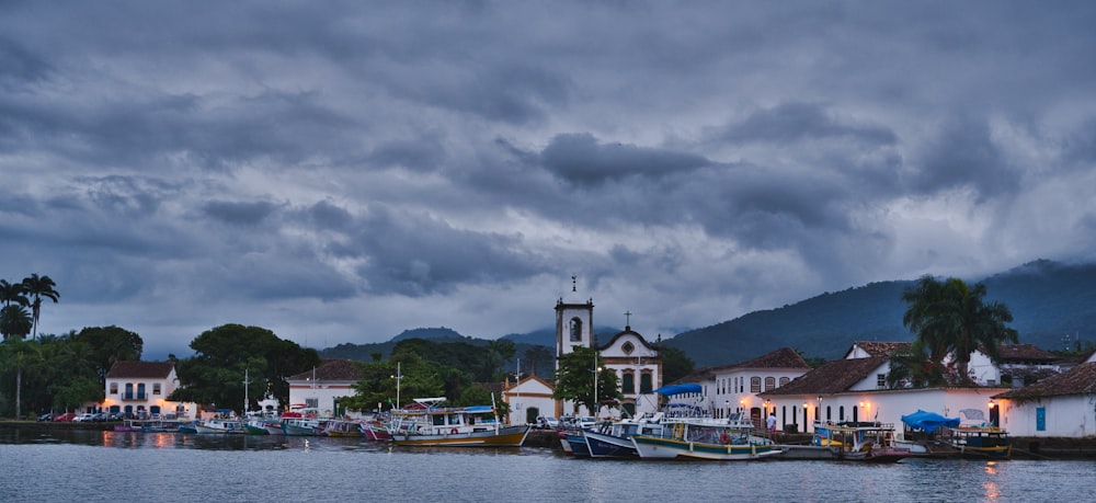 a harbor filled with lots of boats under a cloudy sky