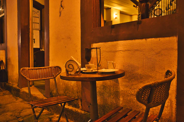 A cozy corner of Nuova with colorful cocktails and coffee cups on a wooden table.