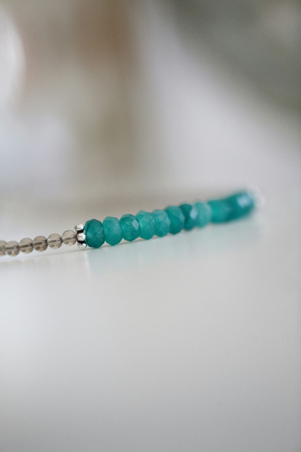 a close up of a beaded necklace on a table