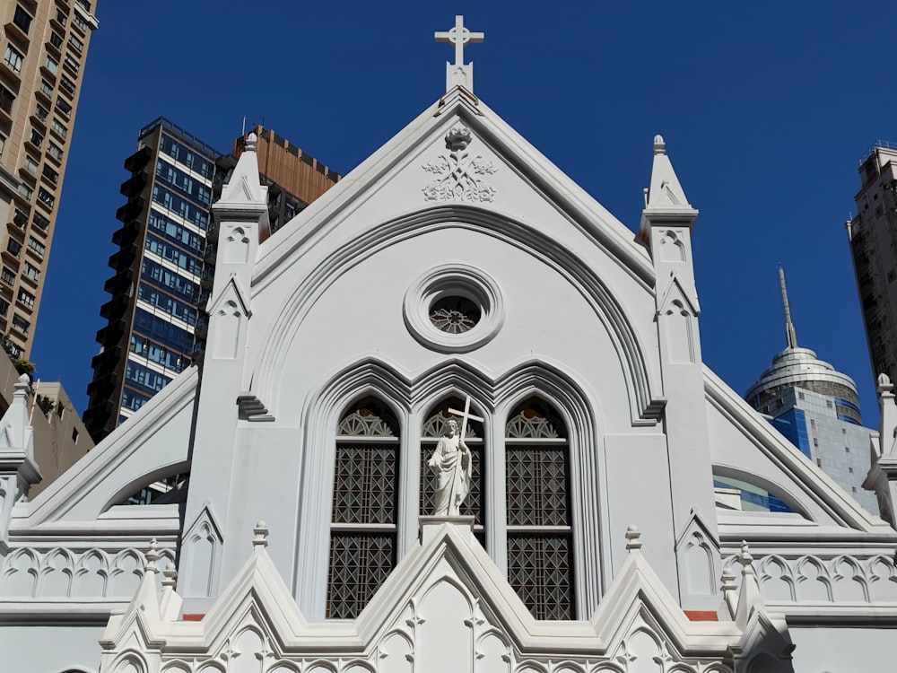 a white church with a cross on the top of it