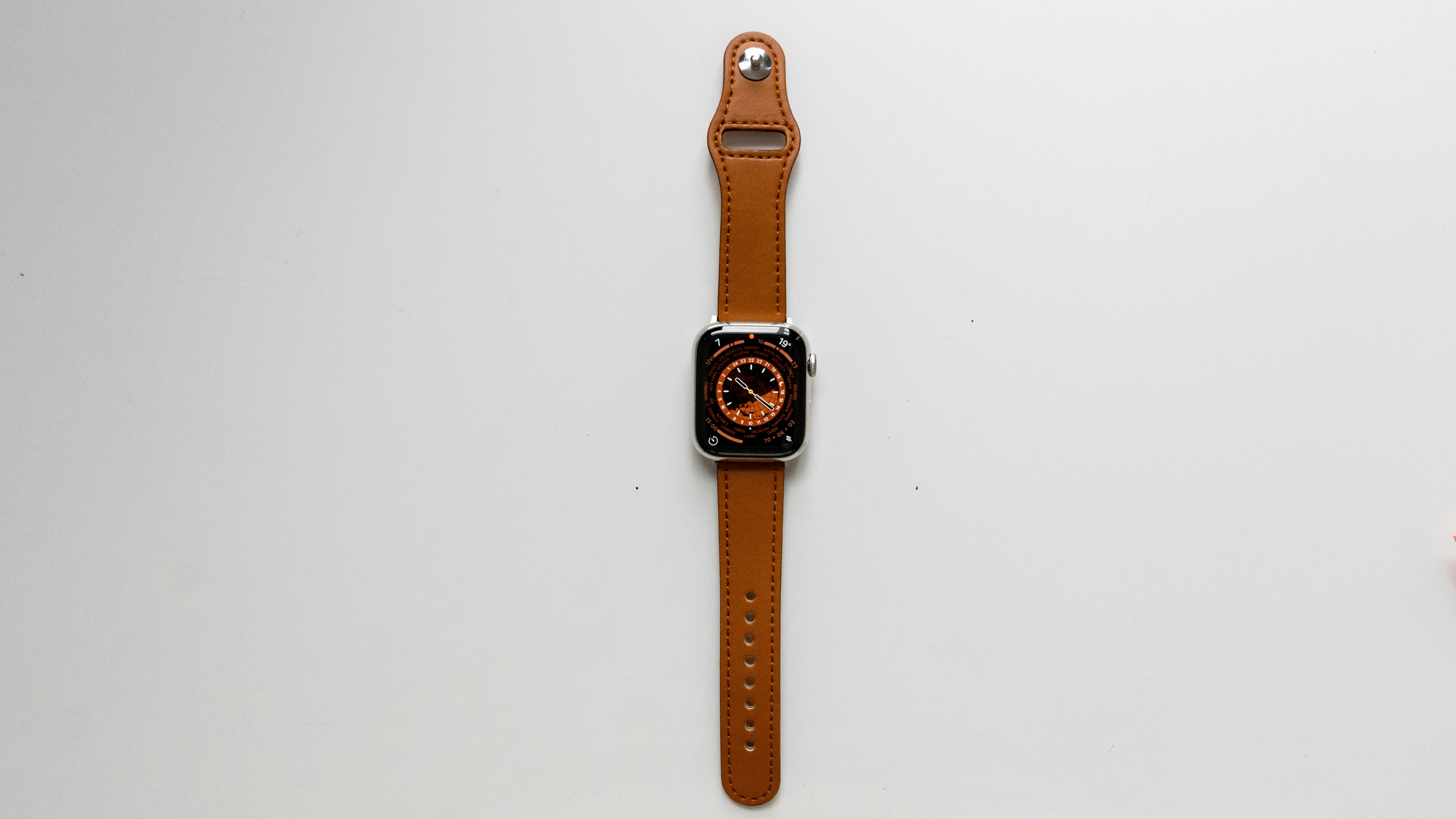 an apple watch sitting on top of a white table