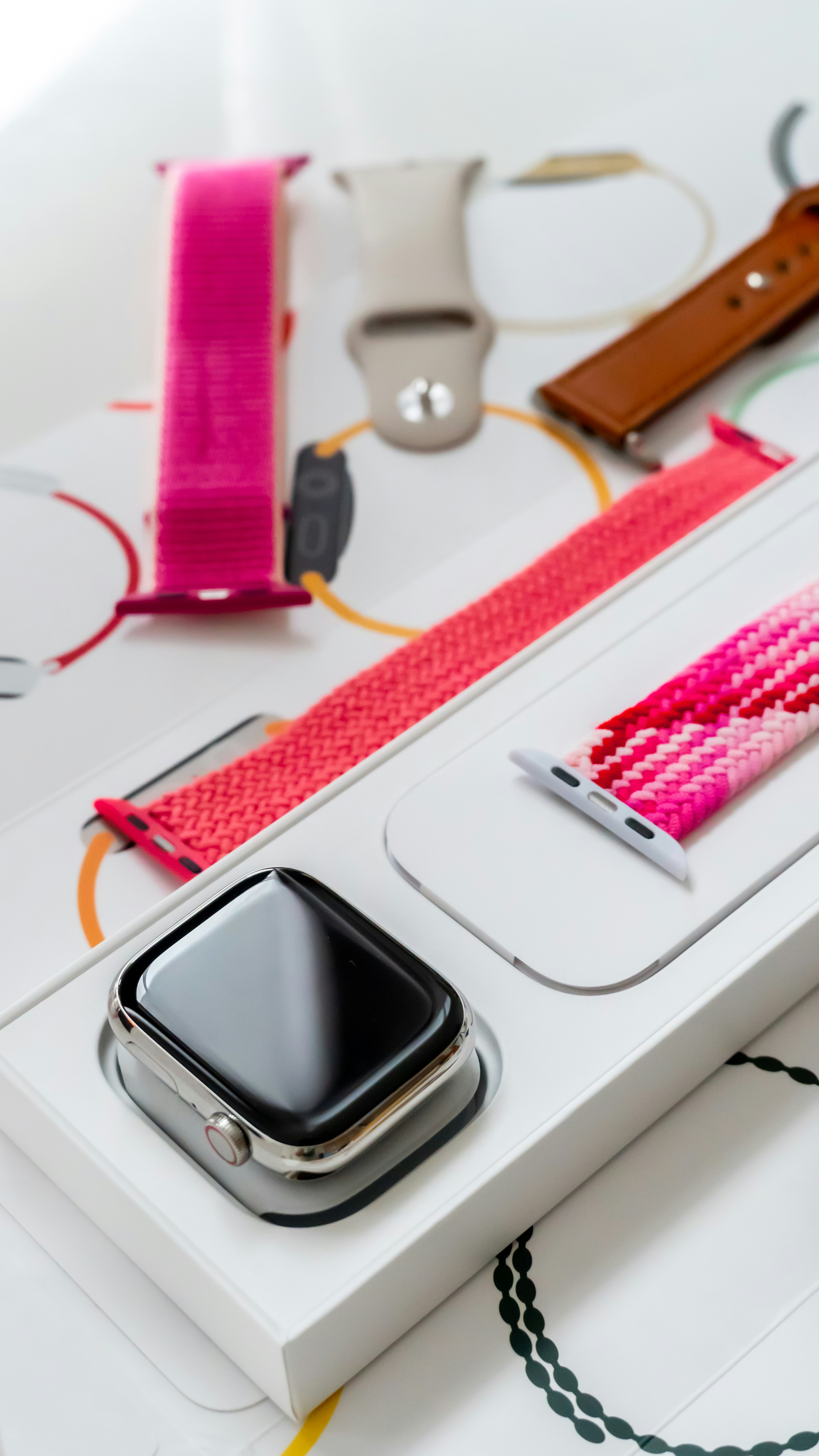 a cell phone and a watch on a table
