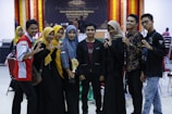 A group of diverse individuals celebrating their achievements.