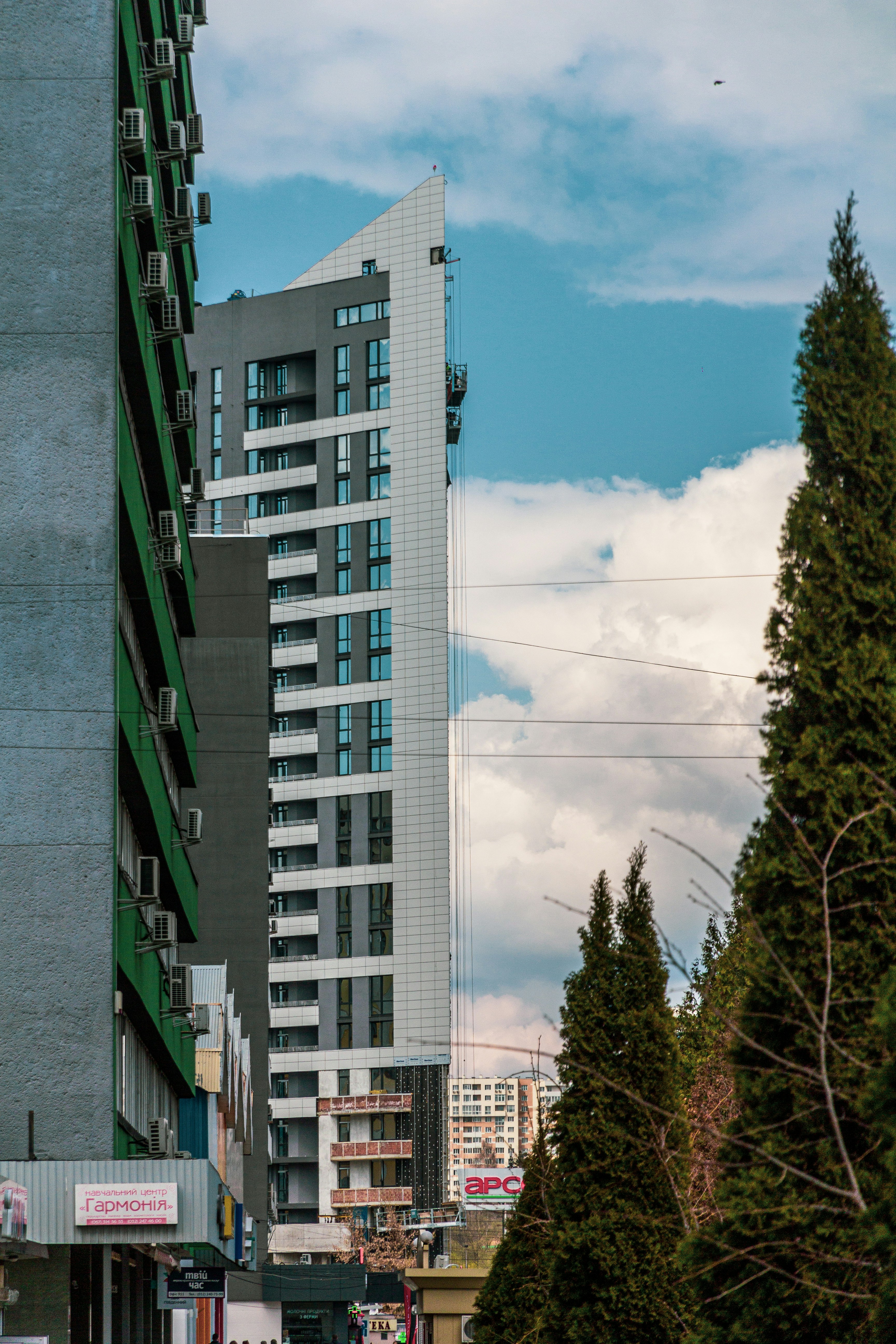 a city street with a tall building in the background