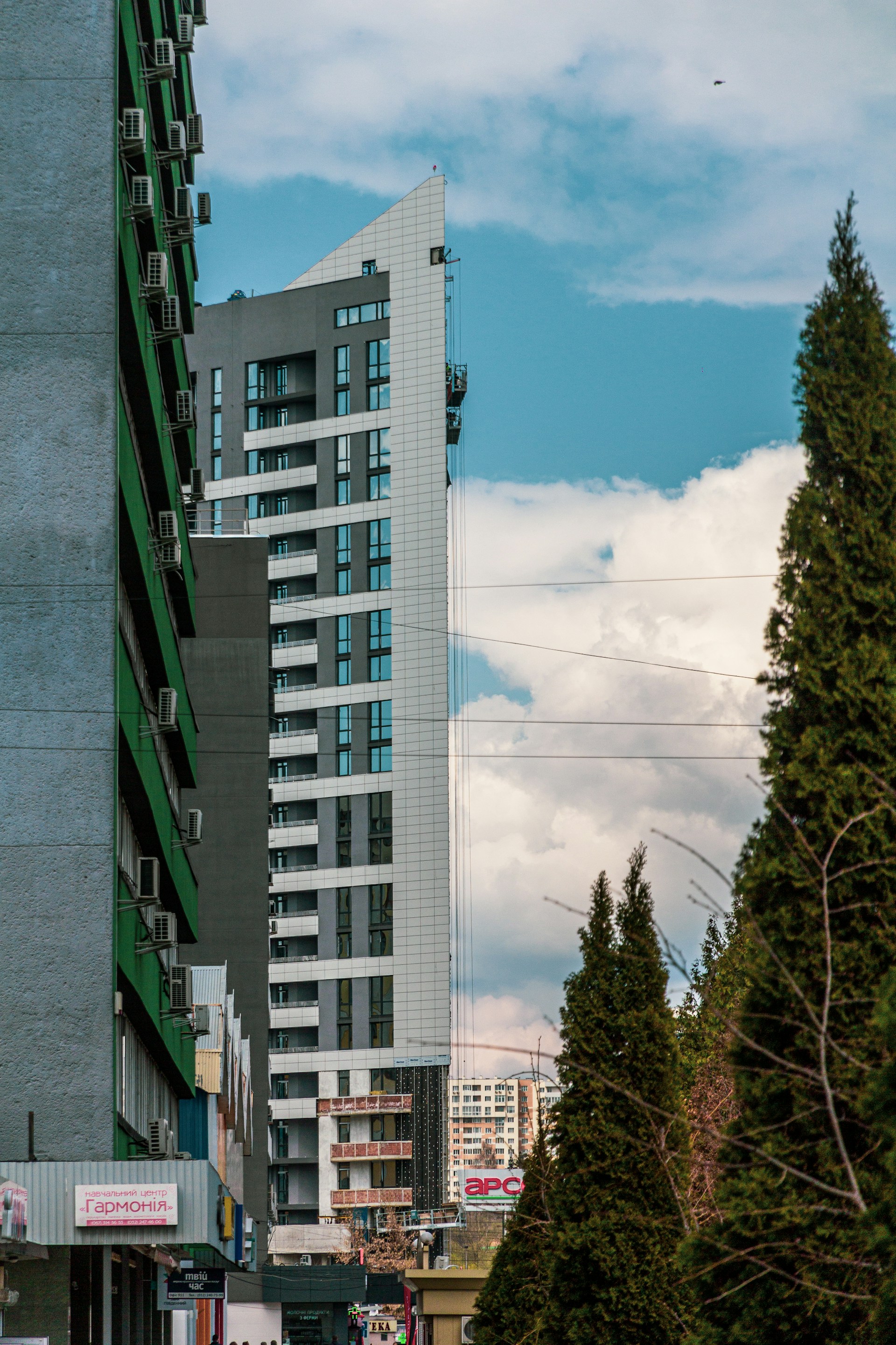 a city street with a tall building in the background