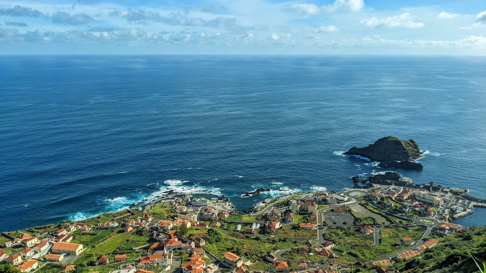 an aerial view of a small village by the ocean