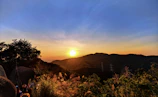 Sunset view over a mountain peak with a small tour group admiring the scenery.