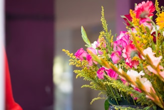 A vibrant bouquet of spring flowers with tulips, daisies, and roses in soft pastel colors.