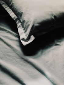 a close up of a pillow on a bed