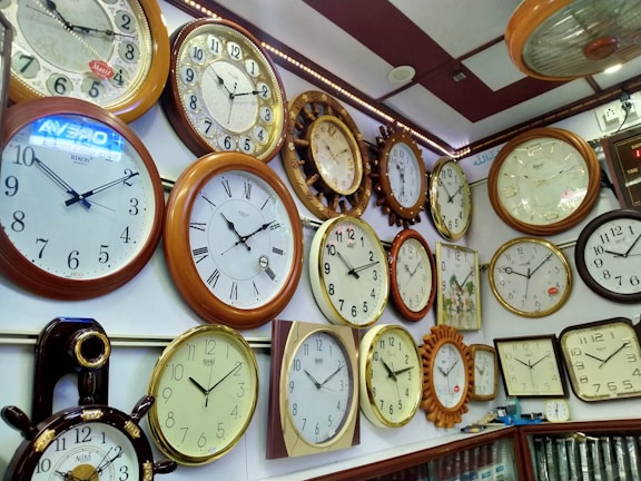 Customized wall clocks with different artistic styles arranged on a wall.