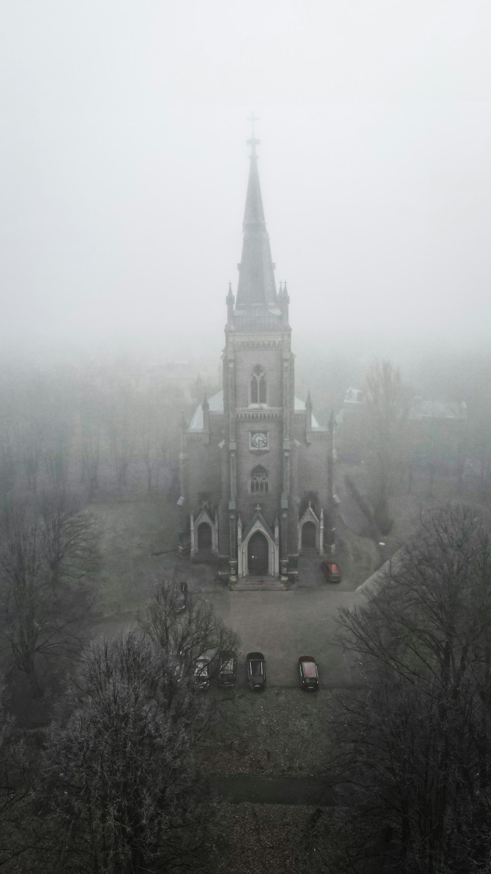 an old church in the middle of a foggy day