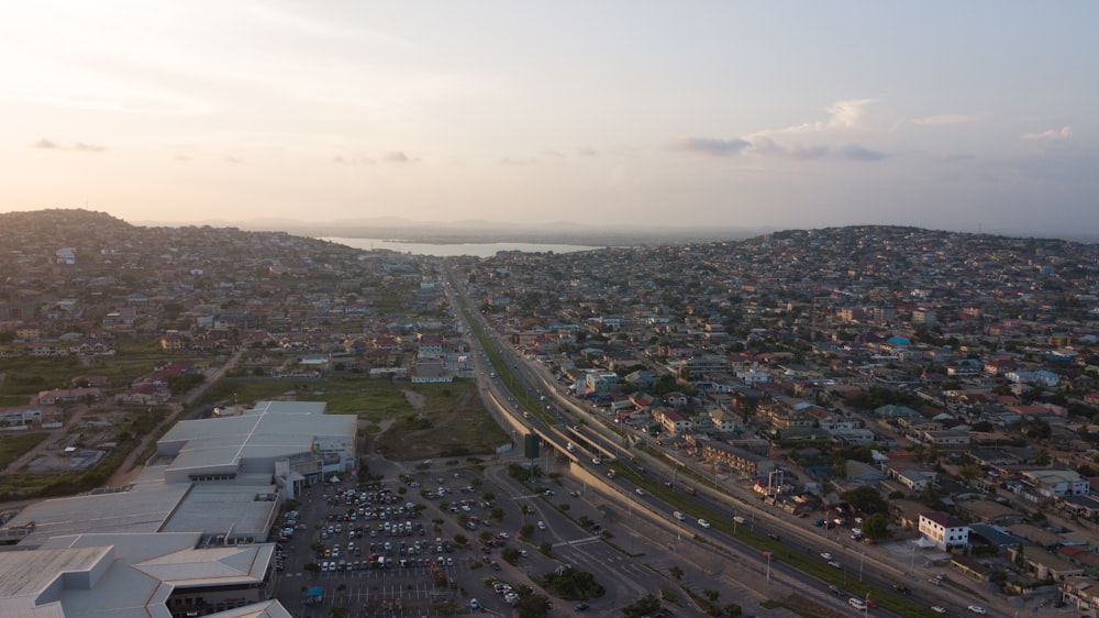 an aerial view of a city with a lake in the background