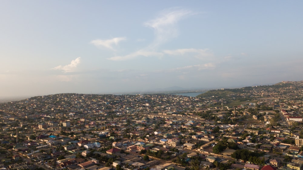 an aerial view of a city with a lake in the distance