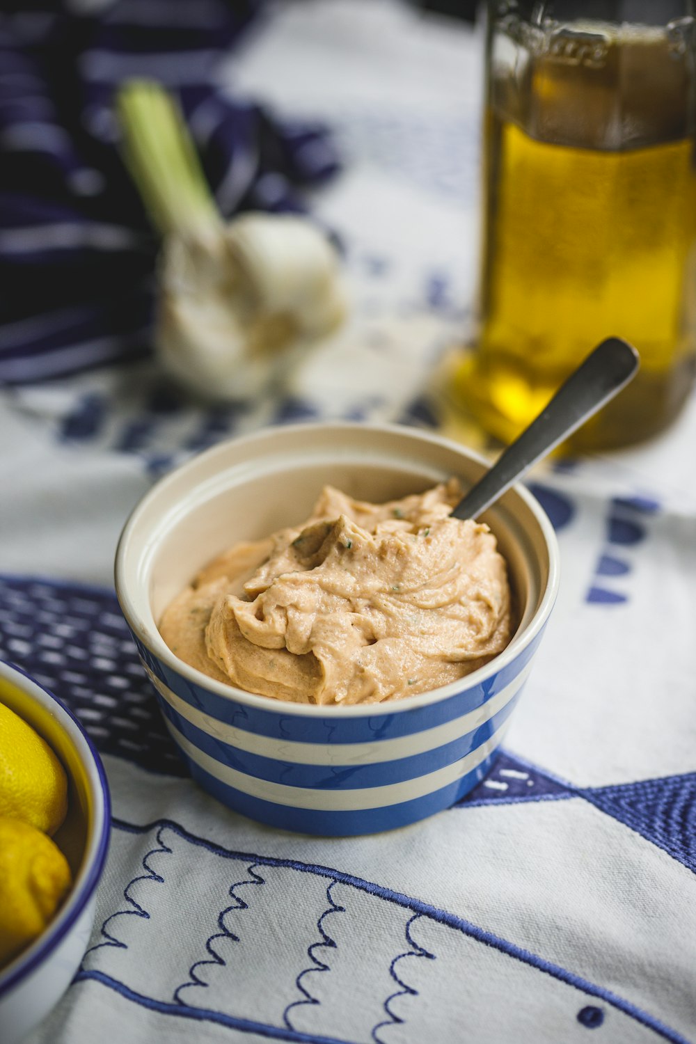 a bowl of hummus next to a bowl of lemons