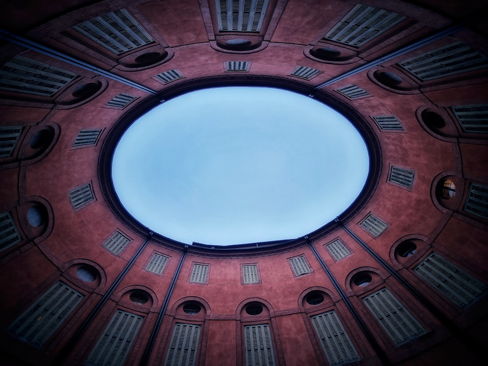 a round window in a building with shutters