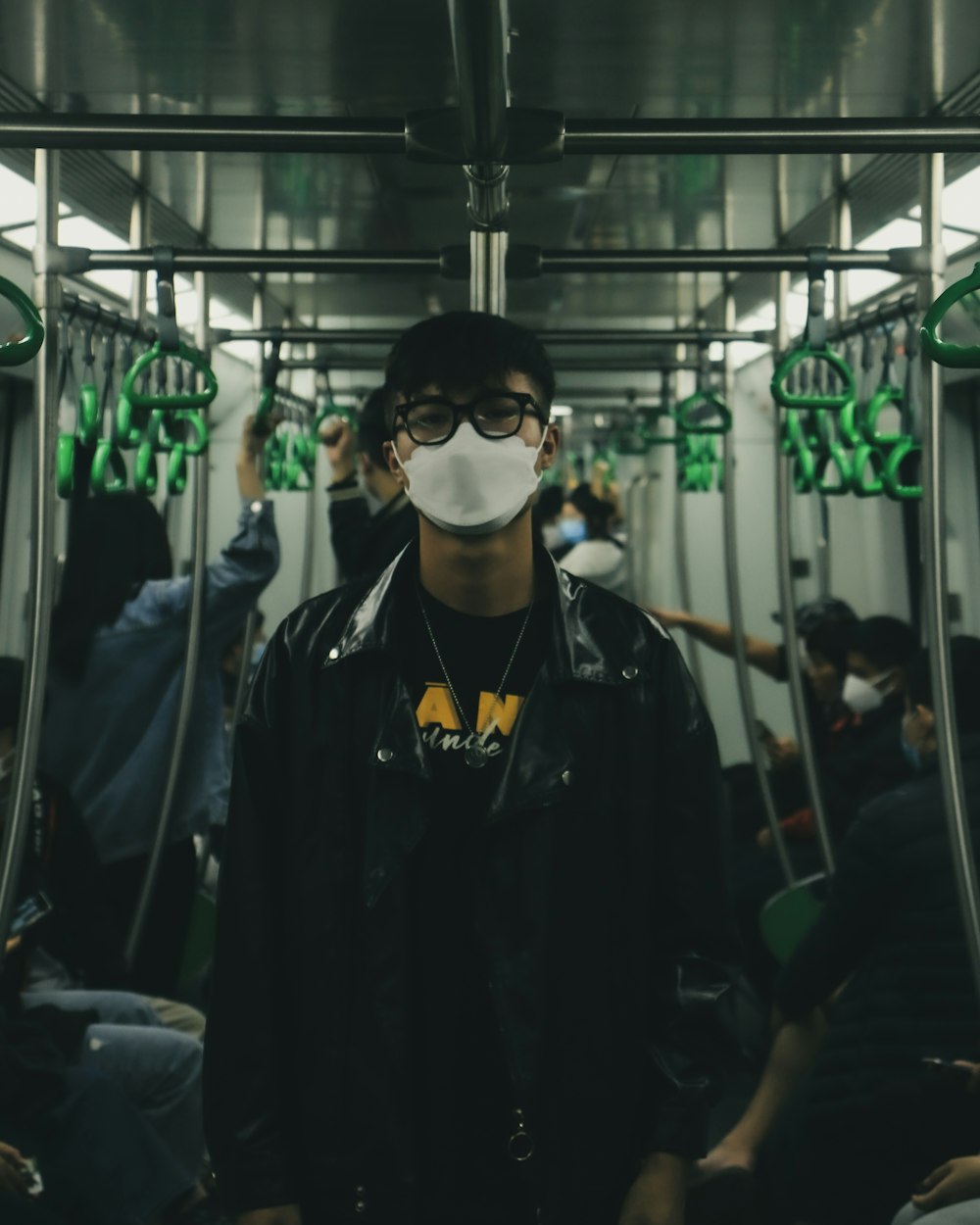 a man wearing a face mask on a subway