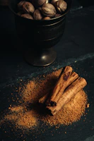 Freshly ground nutmeg dusted over a wooden spoon resting on a spice-strewn table