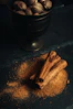 a bowl of nuts and cinnamon sticks on a table