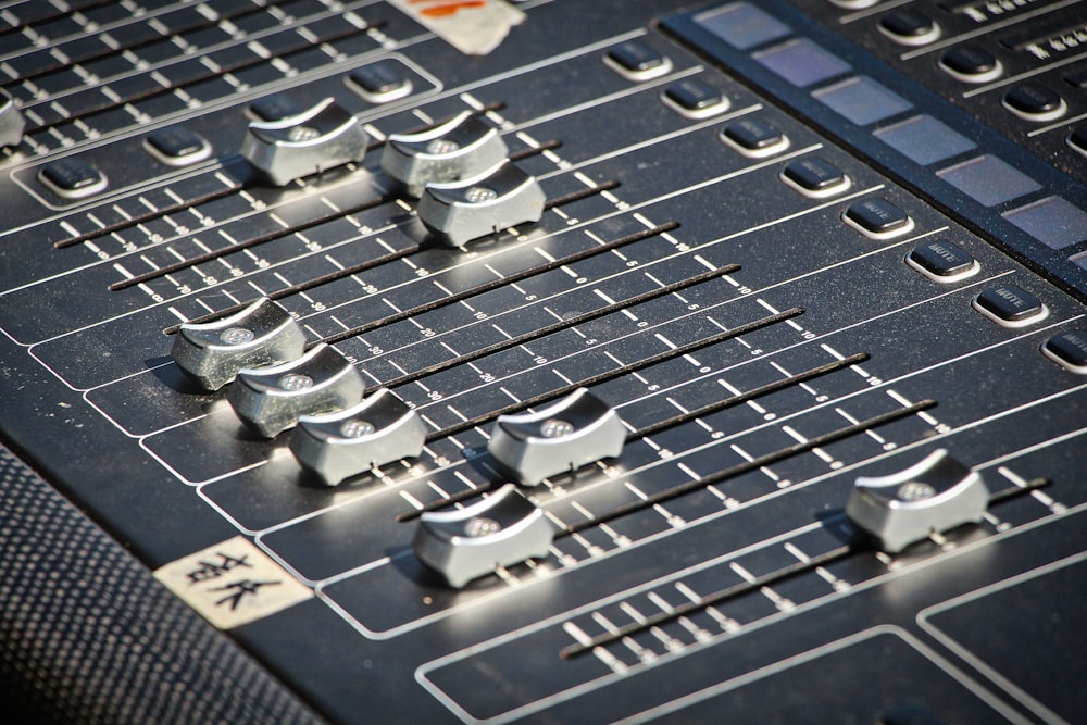 a close up of a mixing board with knobs