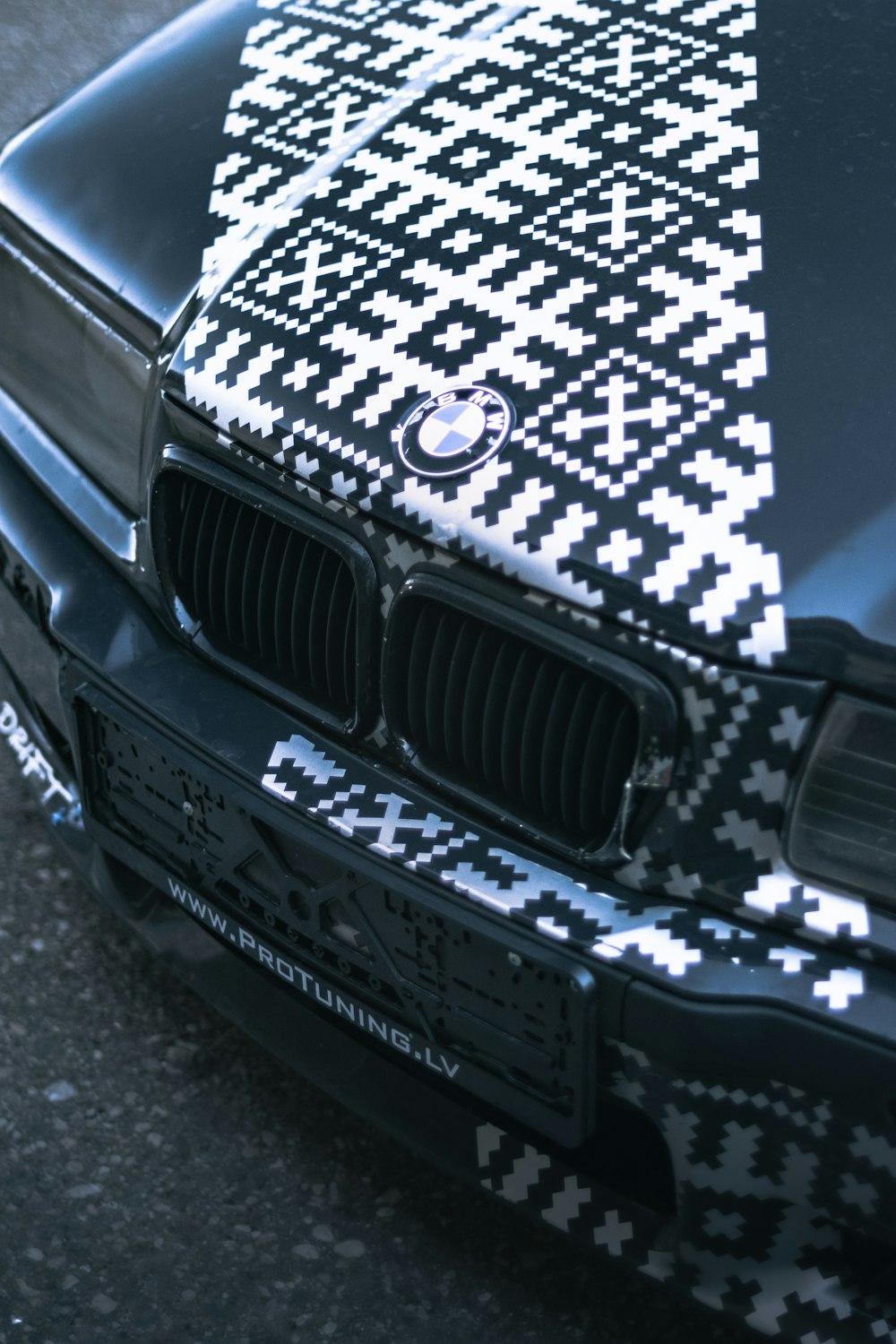 a black and white car is parked on the street