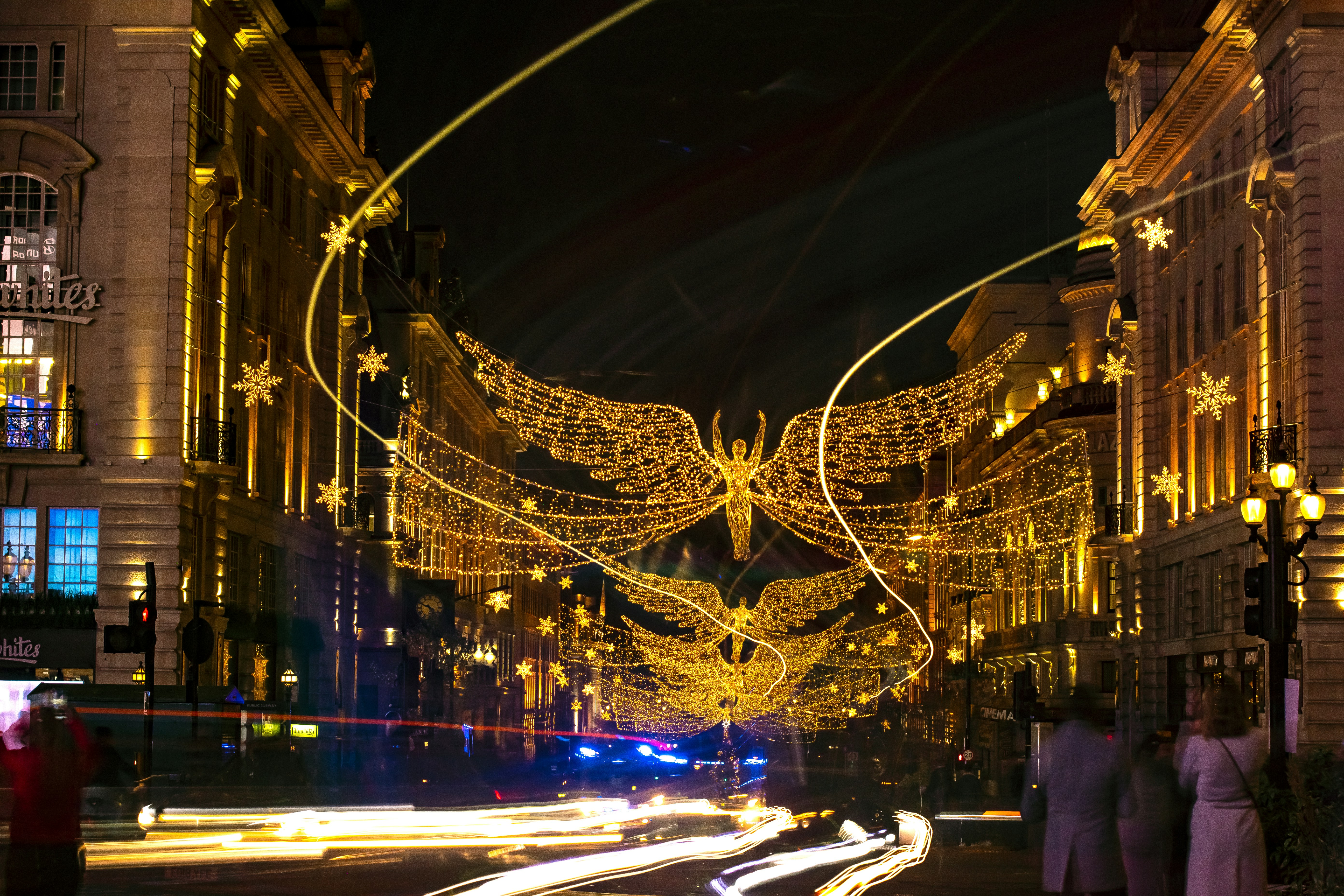 a city street at night decorated with christmas lights