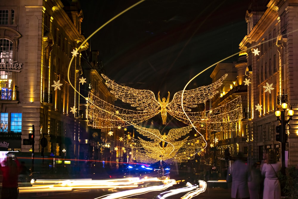 a city street at night decorated with christmas lights