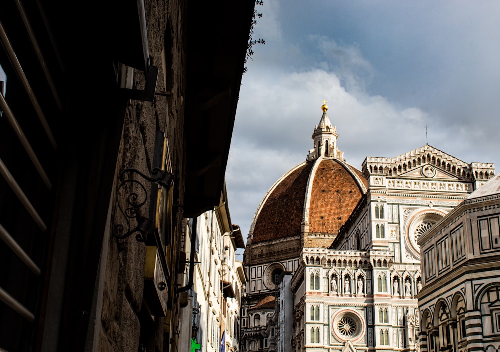 a view of a cathedral from a narrow alleyway