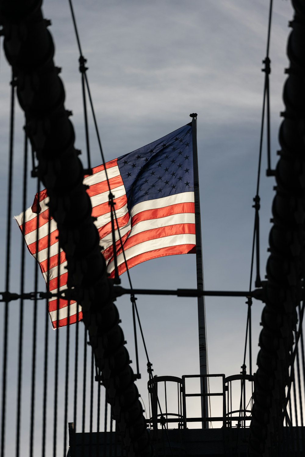 an american flag is seen through a fence