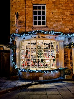 a store front with a lit up christmas tree