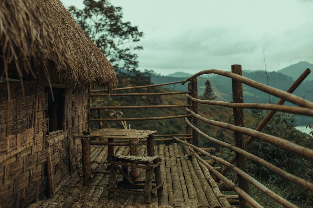 a hut with a thatched roof and a wooden table