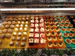 An inviting display of international desserts featuring bright colors and intricate textures.