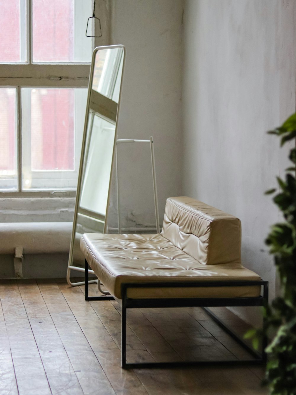 a bed sitting next to a window in a room