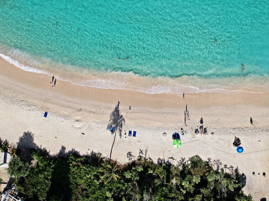 an aerial view of a beach with people on it,
