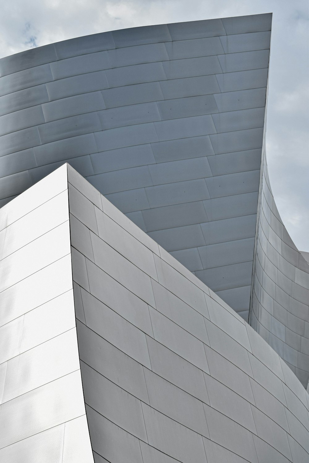 a building with a curved roof and a sky background