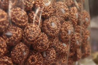 Handcrafted copper circles ready for shipment in packing crates.