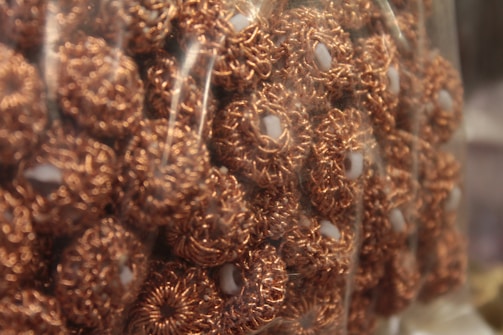 Handcrafted copper circles ready for shipment in packing crates.