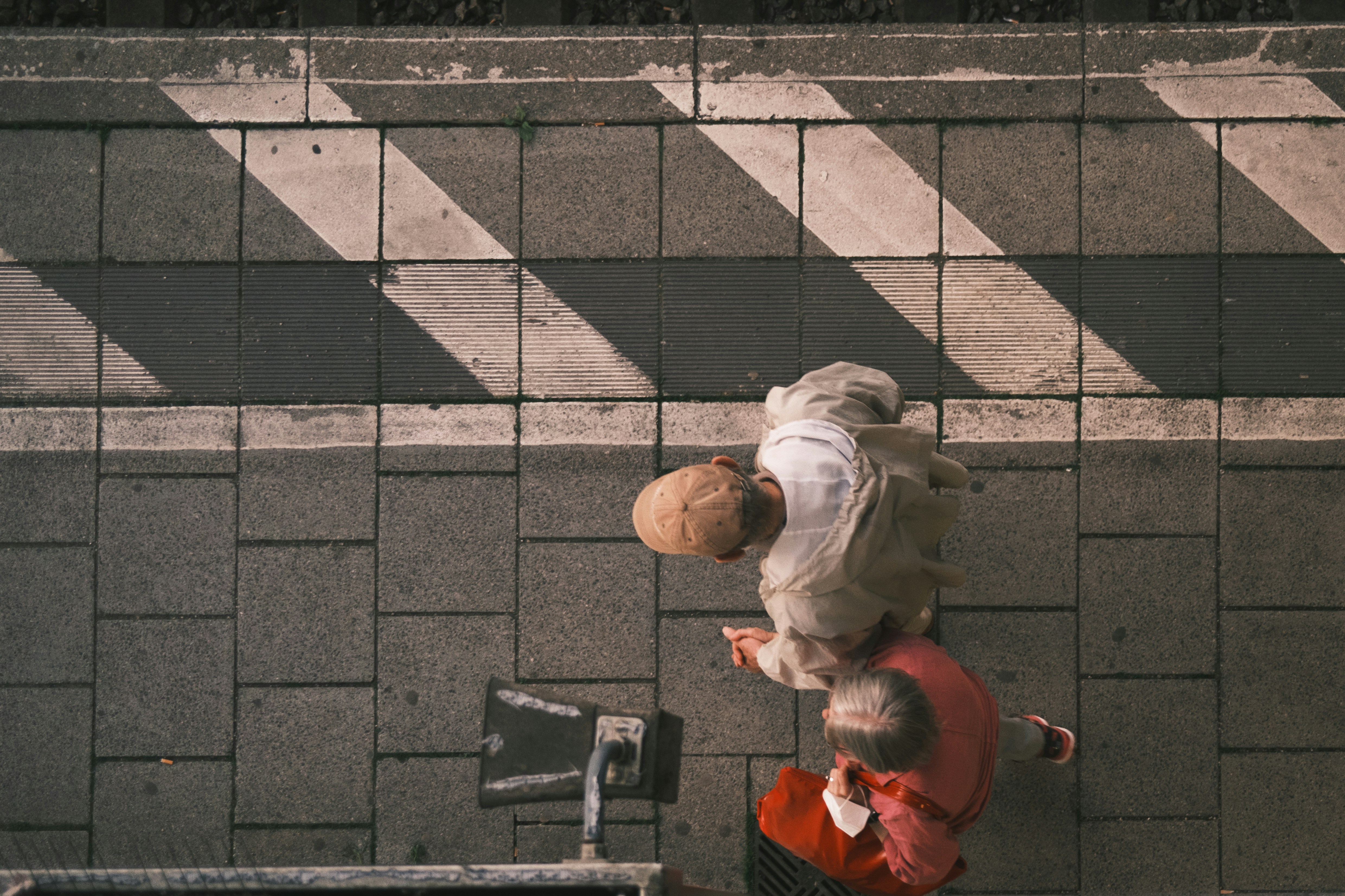 a person walking down a street next to a bike