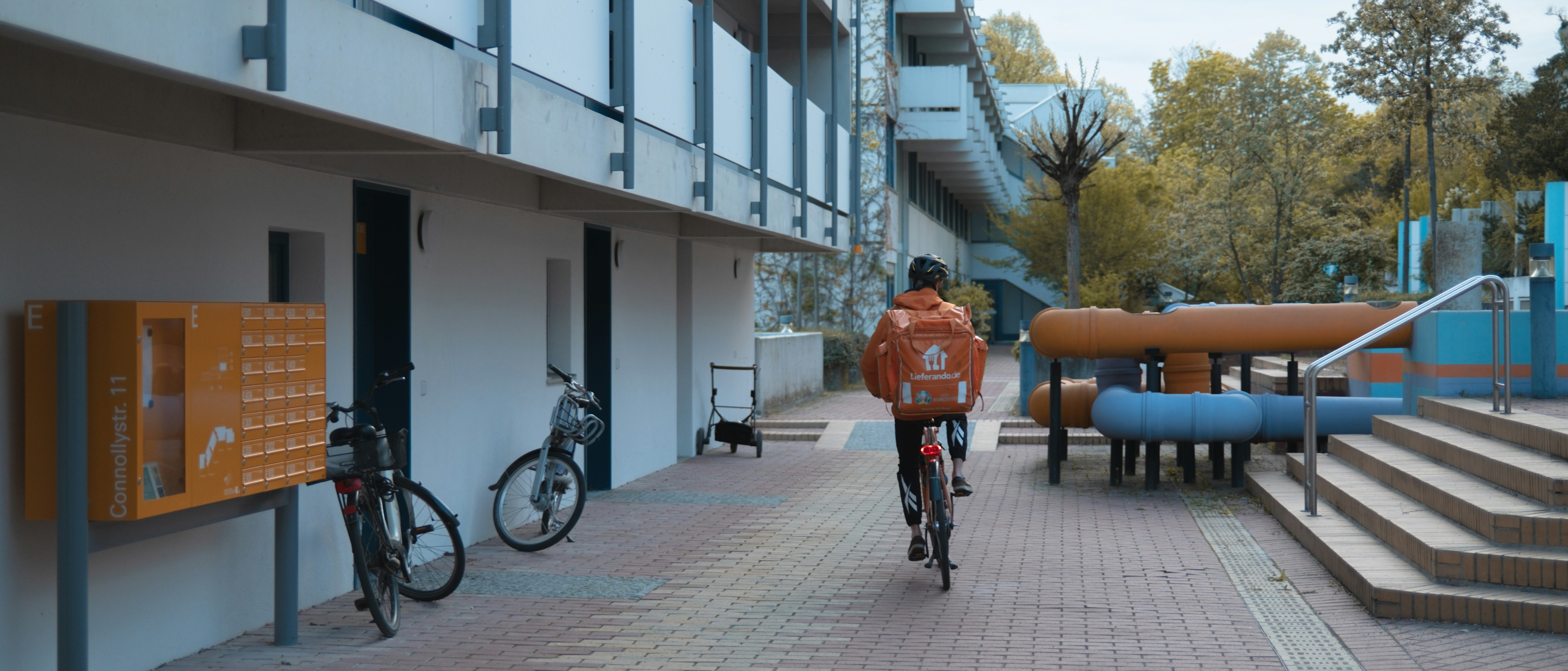 a person riding a bike down a sidewalk