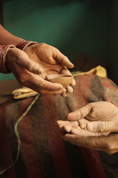 a pair of hands holding a piece of wood
