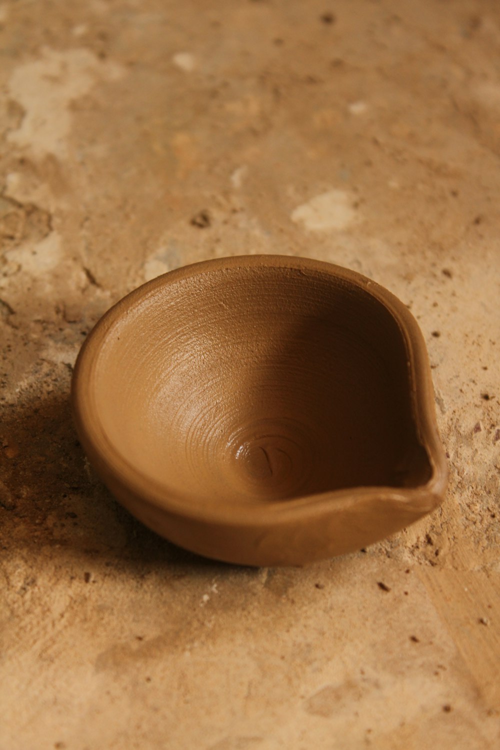 a brown bowl sitting on top of a counter