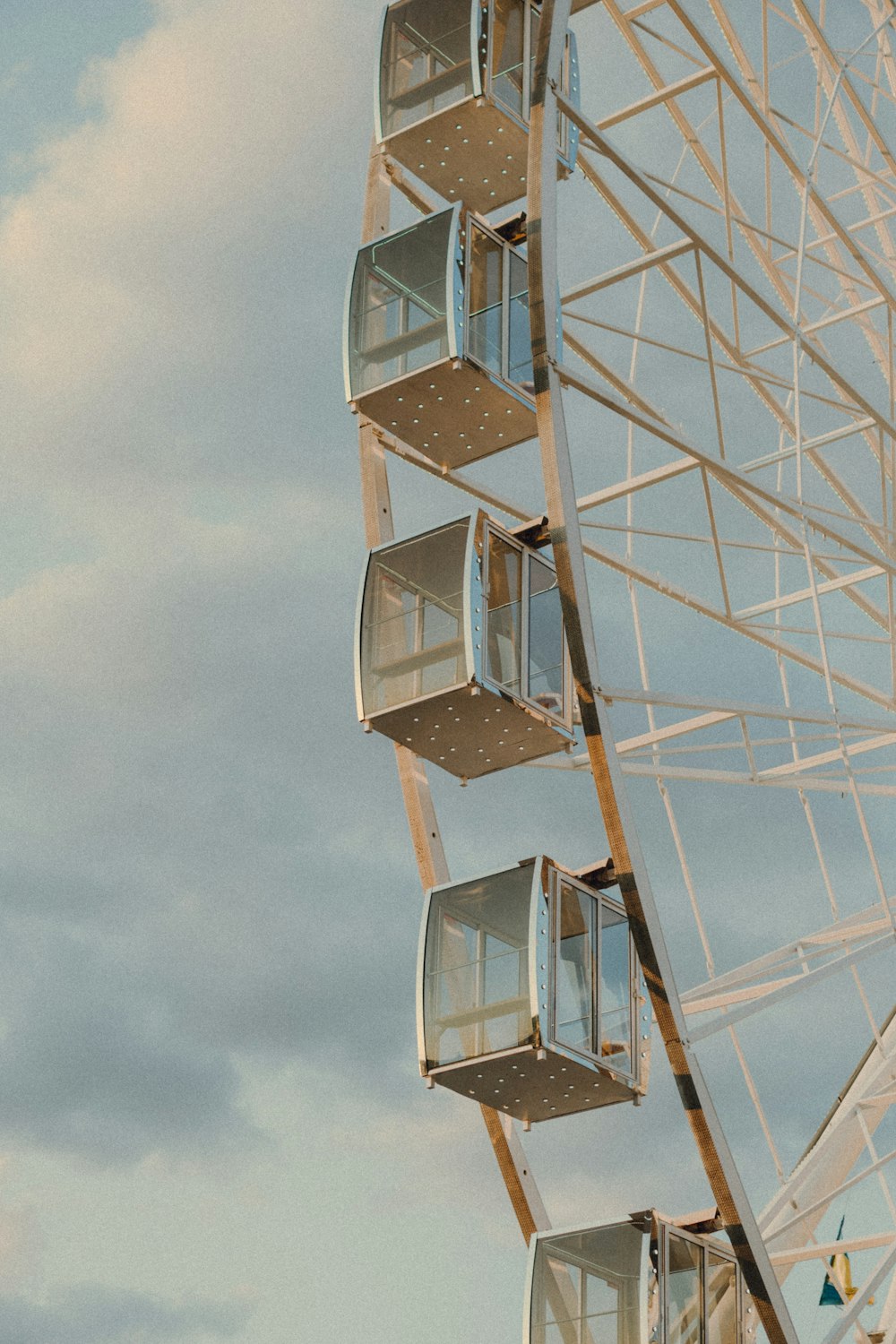 a large ferris wheel sitting under a cloudy sky