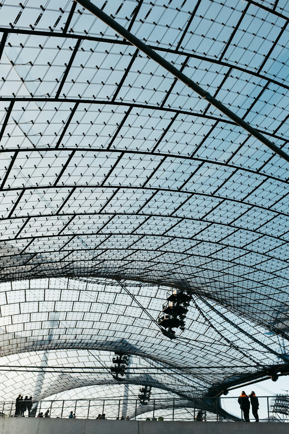 a group of people standing under a metal roof