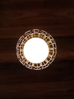 Technician installing modern light fixtures on a wooden ceiling