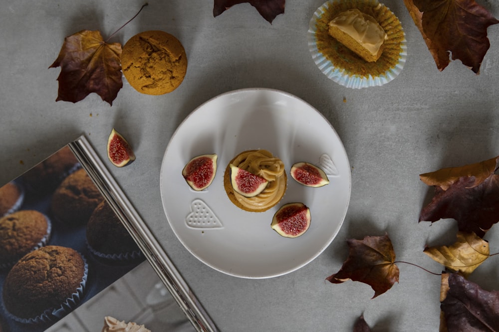 a white plate topped with muffins next to a cupcake